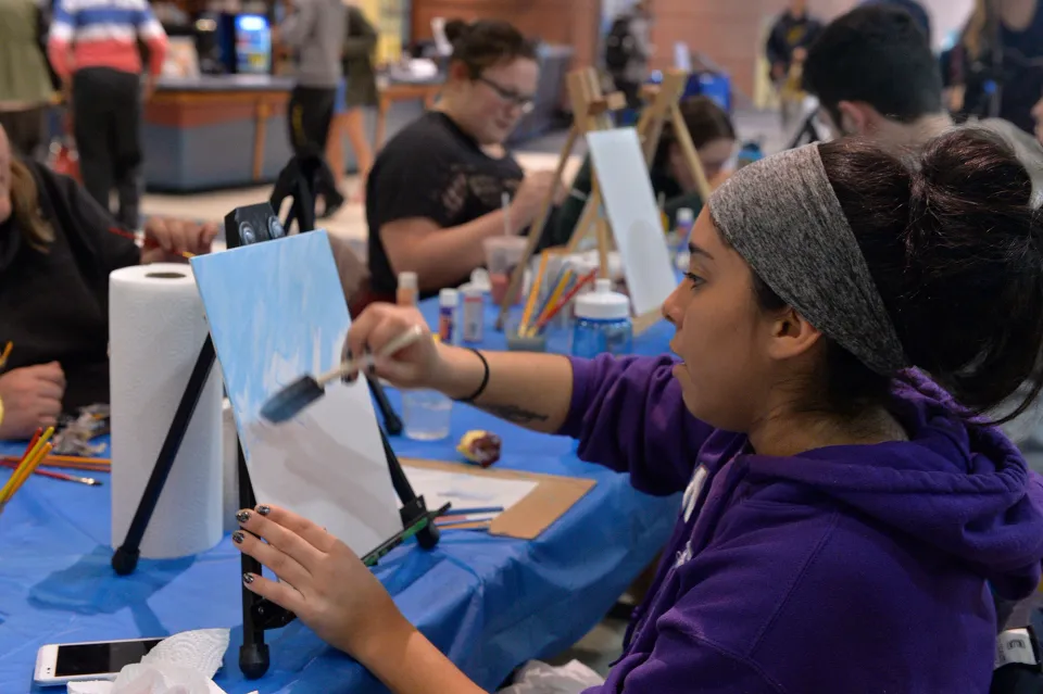 A student painting a canvas at ChillFest